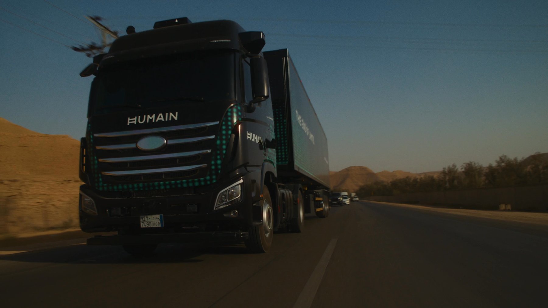 Autonomous truck driving across an open landscape